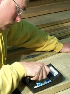 Worker measuring wood moisture