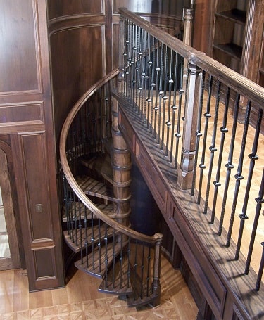 Spiral stair to library made from oak with metal balusters