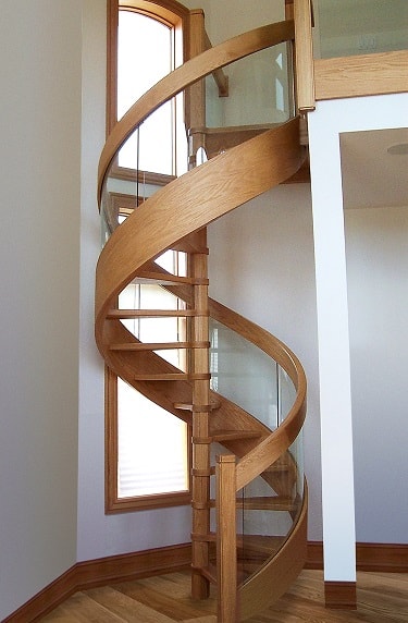 Oak spiral stair with glass balustrade and oak rail