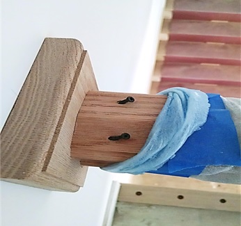 Partially screwed-in rails allow for easy removal in order to install balusters after they are finished by painter.