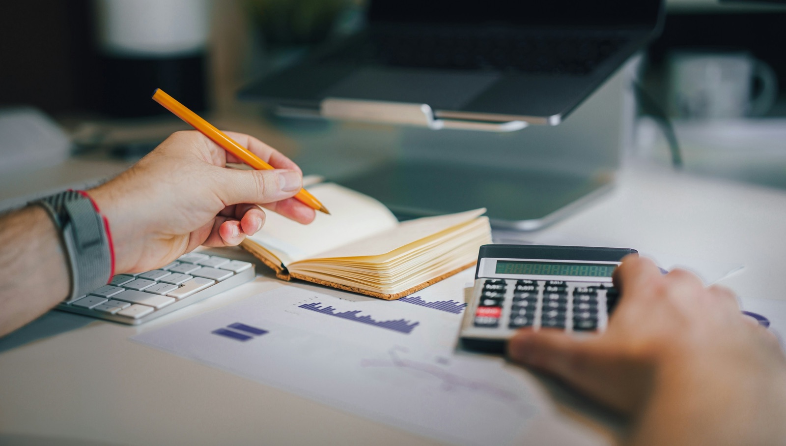 Planning a home budget with a calculator, notes, and charts